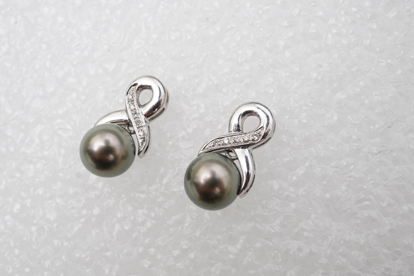 A pair of cultured pearl and diamond earrings